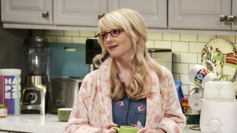 Bernadette in a pink robe drinking coffee on The Big Bang Theory