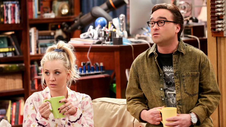 Penny and Leonard drinking coffee and sitting in the living room on The Big Bang Theory