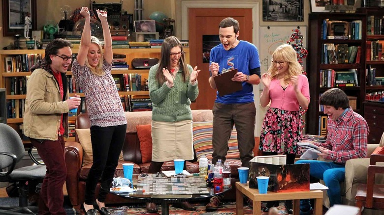 Leonard, Penny, Amy, Sheldon, Bernadette, and Howard all cheering in the living room on The Big Bang Theory