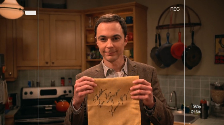 Jim Parsons as Sheldon Cooper holding a signed napkin from Leonard Nimoy on The Big Bang Theory