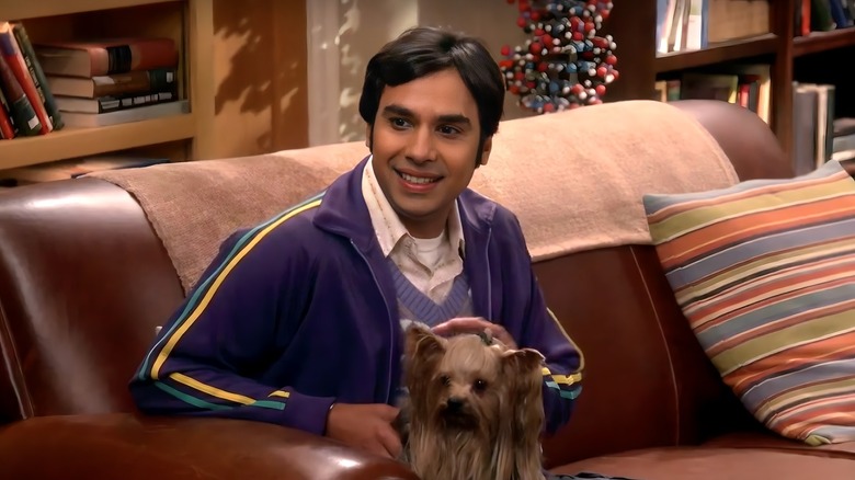 Raj holding dog on couch