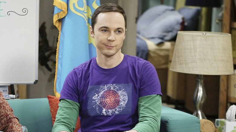 Sheldon Cooper sitting on a couch and smirking on The Big Bang Theory