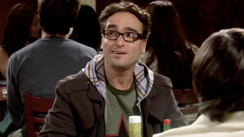 Leonard looking up and smiling wearing a hoodie in The Big Bang Theory