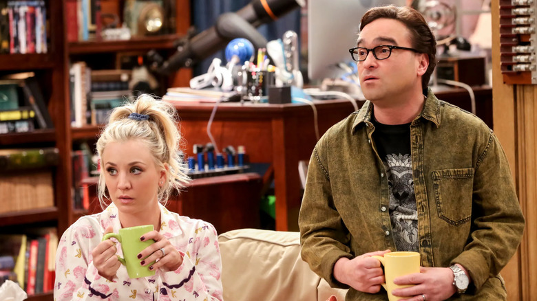 Penny and Leonard drinking coffee and sitting in the living room on The Big Bang Theory