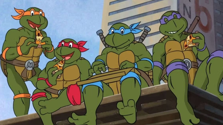 Michelangelo, Raphael, Leonardo, and Donatello on Teenage Mutant Ninja Turtles, eating pizza on a rooftop