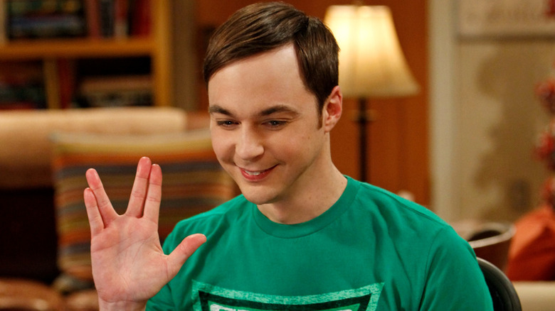 Sheldon smiling and doing the Klingon salute on The Big Bang Theory