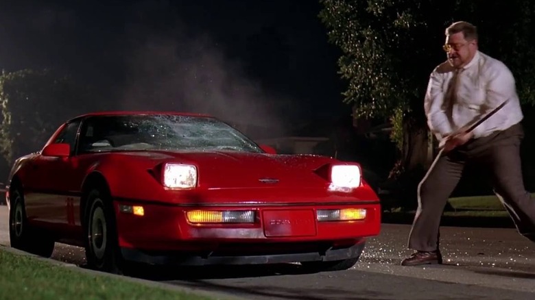 John Goodman destroying red sports car