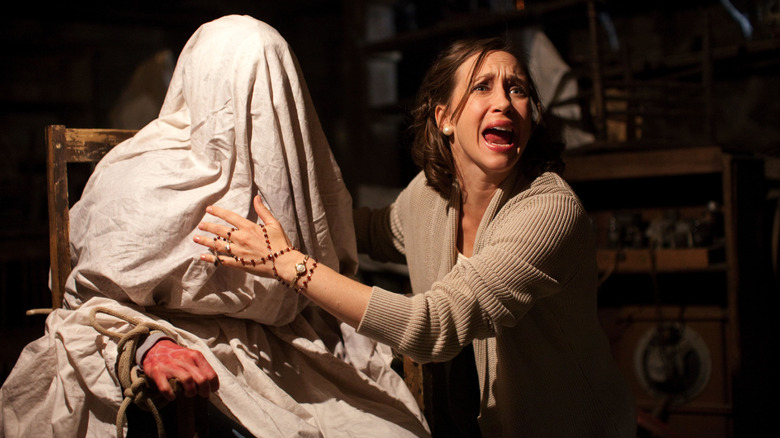 Lorraine Warren yelling with covered person in The Conjuring