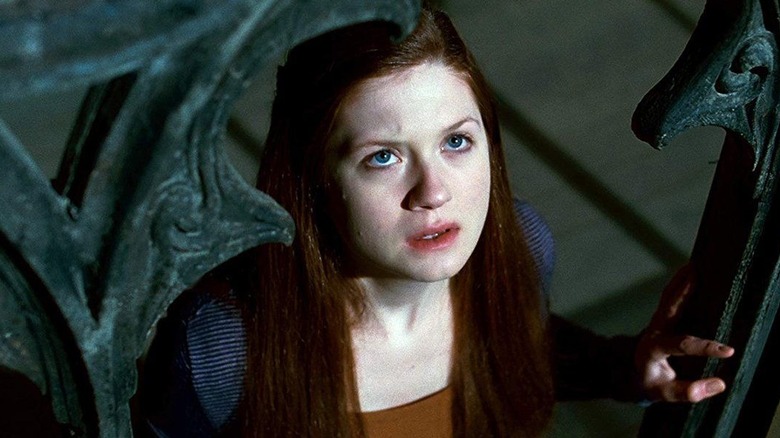 Ginny in the Hogwarts ramparts looking up in Harry Potter and the Deathly Hallows: Part 2