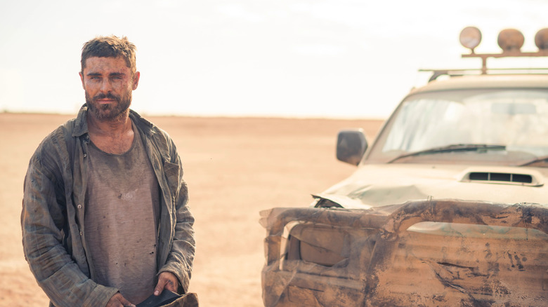 Zac Efron standing in desert