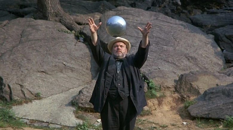 Orson Welles as Magician ponders the orb in A Safe Place