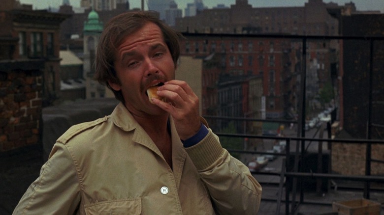 Jack Nicholson eats a roll as Mitch in A Safe Place