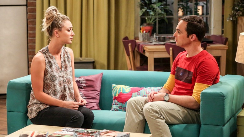 Kaley Cuoco's Penny and Jim Parsons' Sheldon sitting on the couch talking in The Big Bang Theory