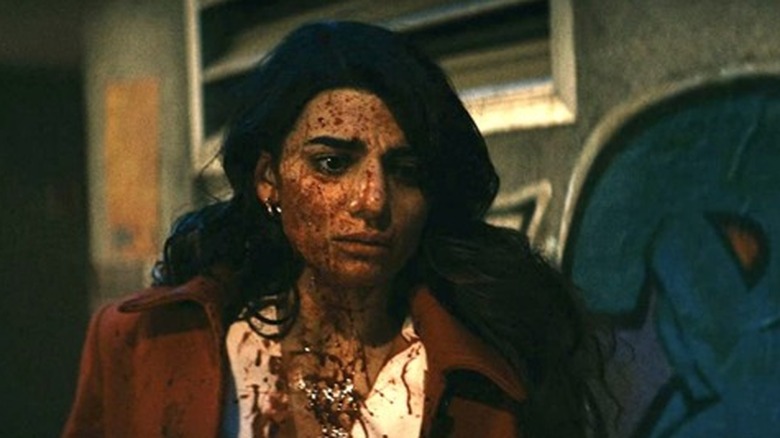 Claudia Doumit covered in blood