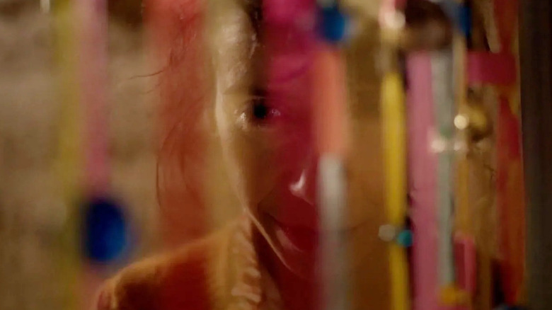 A shot of a distressed woman in a reflection in Bring Her Back