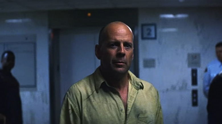 David Dunn standing in a hospital in Unbreakable, looking at the camera