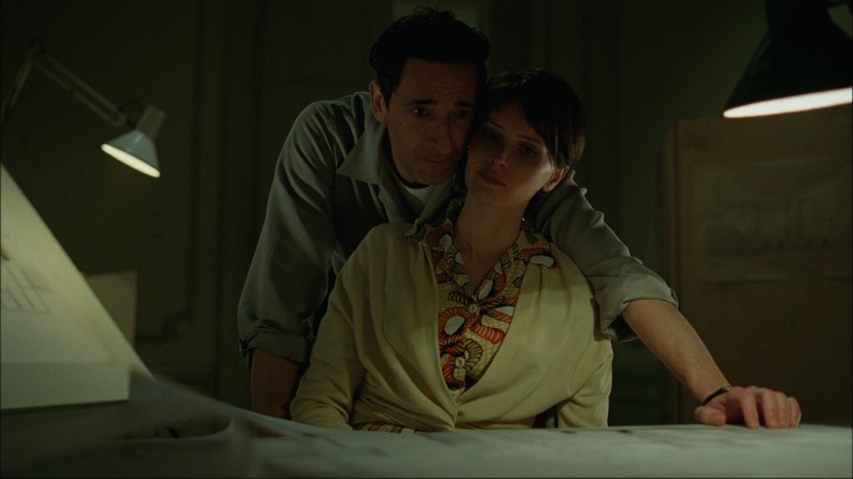 Adrien Brody and Felicity Jones as László and Erzsébet get close in The Brutalist