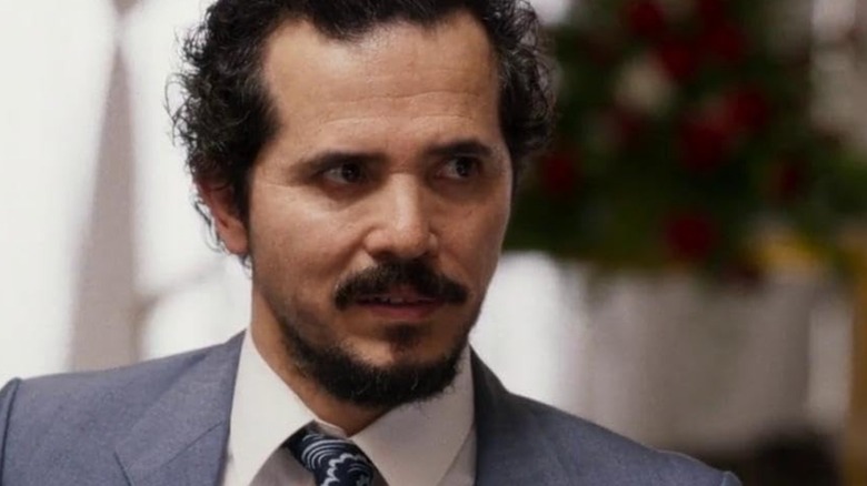 John Leguizamo's Emir looking to his left, wearing a suit in The Infiltrators