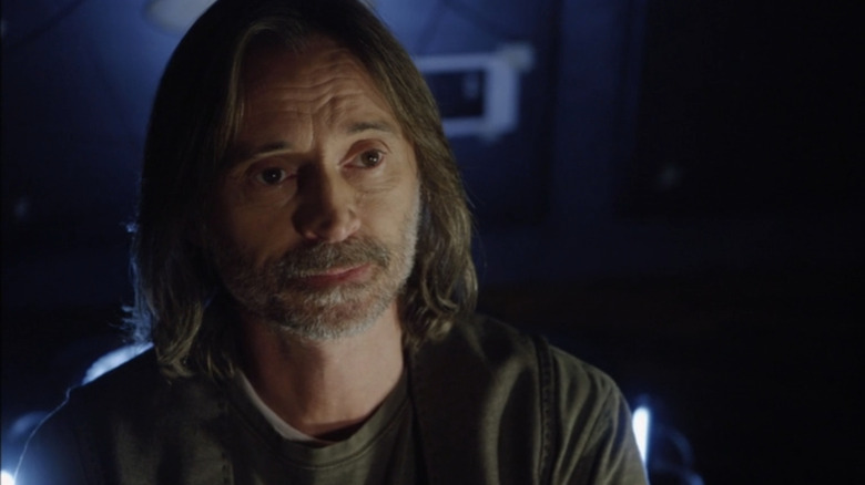 Robert Carlyle's Nicholas Rush looks across frame in Stargate Universe