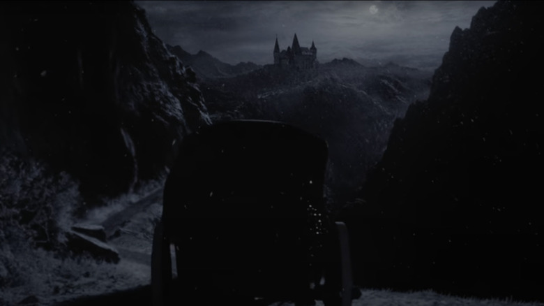 Coach approaches Orlock Castle, which is seen at the distant distance in nosferatu