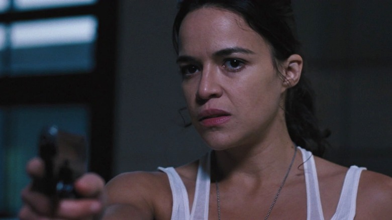 Letty in white tank top holding gun in Fast & Furious 6