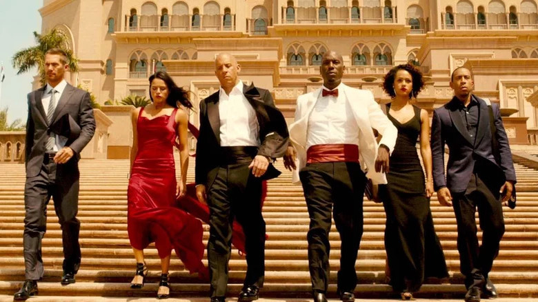 The Furious 7 cast walking down steps in fancy outfits