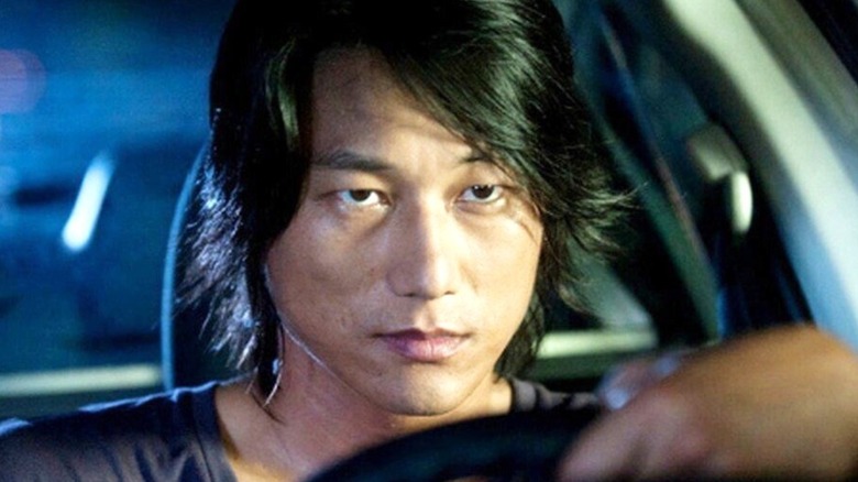 Han in front of the wheel in Tokyo Drift