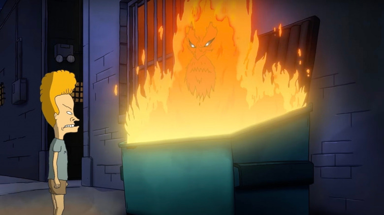 Beavis looking at a flaming dumpster. The fire has a human face in it.