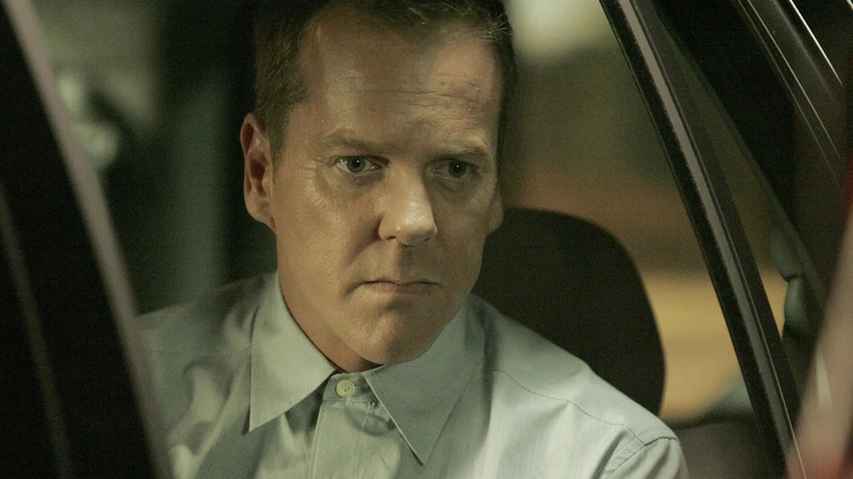 Jack Bauer, looking intense in close-up while sitting in a car on 24