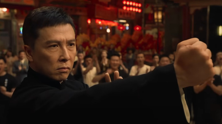 Ip Man raises his fist with a stern face in Ip Man 4