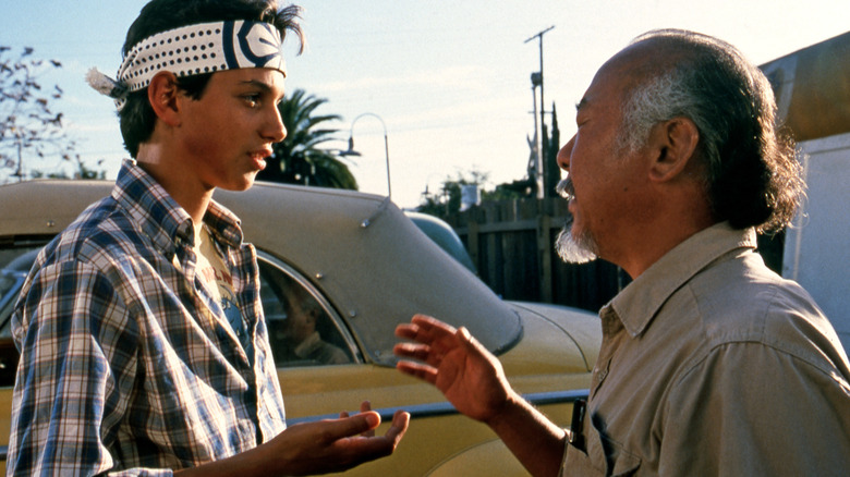 Mr. Miyagi talking to Daniel LaRusso in the driveway in The Karate Kid