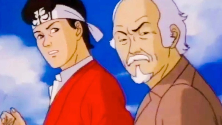 Animated Daniel LaRusso and Mr. Miyagi turning their heads with worried expressions in The Karate Kid (1989)