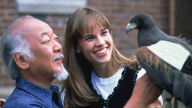 Julie and Mr. Miyagi smiling at a bird in The Next Karate Kid