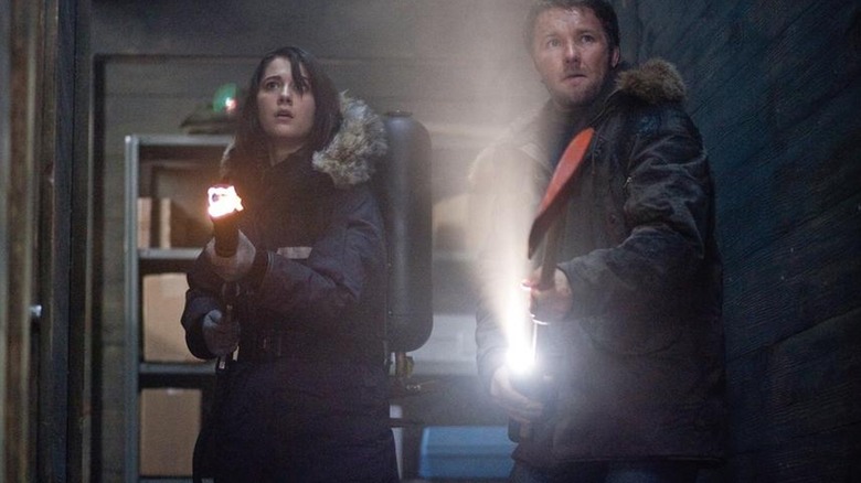 Kate Lloyd and Sam Carter wielding weapons in The Thing (2011)