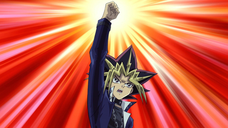 Yugi Moto throwing his fist in the air triumphantly in Yu-Gi-Oh!