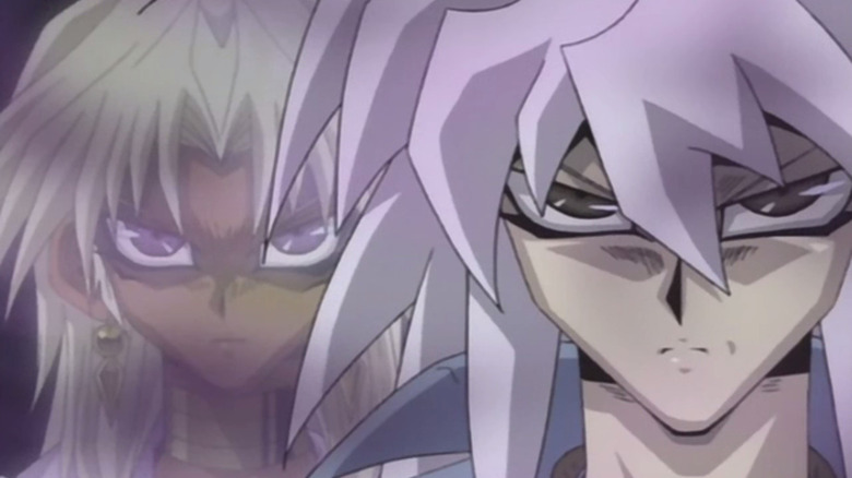 Marik Ishtar looming over Bakura's shoulder during a duel in Yu-Gi-Oh!