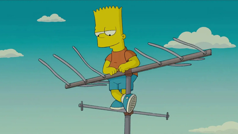 Bart Simpson standing on a rooftop TV antenna