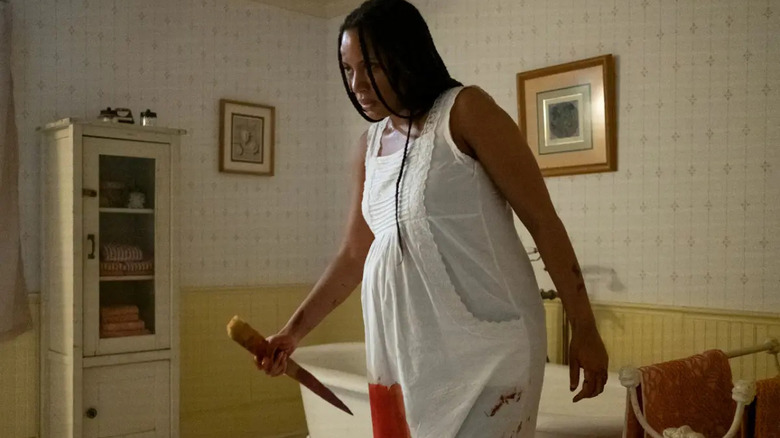 Natalie Paul with a knife in Delivered 