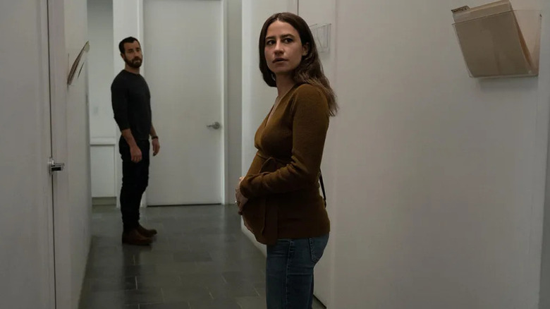 Justin Theroux and Ilana Glazer standing in the hallway in False Positive 