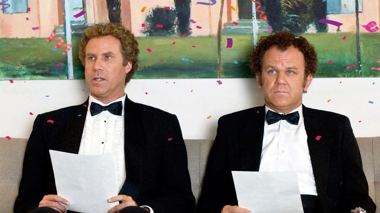 john c reilly and will ferrell sitting next to one another in suits in the movie step brothers