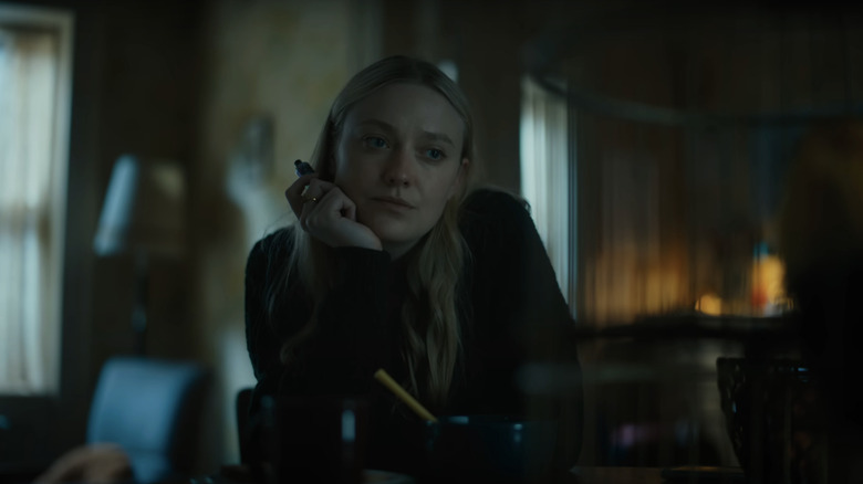 Dakota Fanning's Mina/Lucy sits in a living room in The Watchers