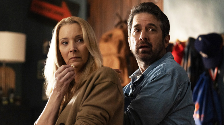 Ray Romano's Paul and Lisa Kudrow 's Lydia sit together and look over their shoulders in No Good Deed