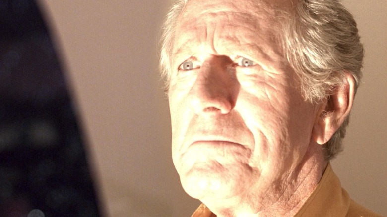 A closeup of Kevin Uxbridge, his face bathed in light, on an episode of Star Trek: The Next Generation.