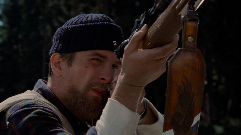 Robert De Niro pointing a gun in The Deer Hunter