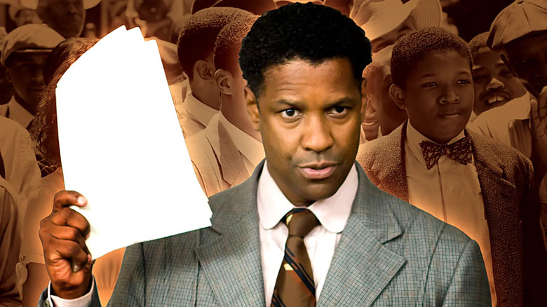 Denzel Washington as Professor Melvin Tolson holding a stack of papers with his students in the background from The Great Debaters