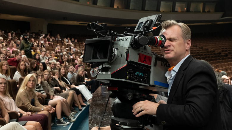 Christopher Nolan filming a scene for Tenet with an IMAX camera