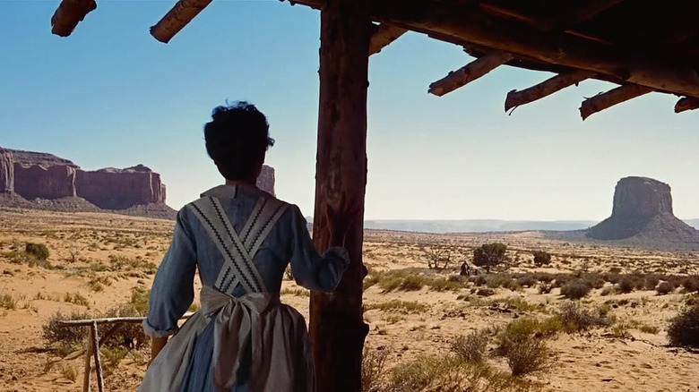 A woman looks out at the desert in The Searchers