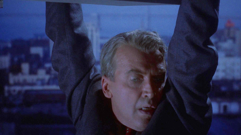 James Stewart as Scottie Ferguson holding onto the edge of a building on Vertigo