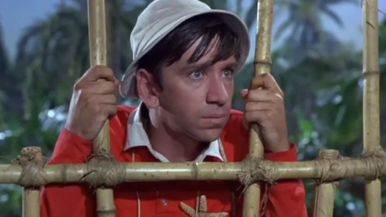 Bob Denver's Gilligan looks out from between the bars of a bamboo jail cell in Gilligan's Island