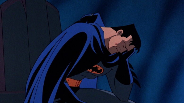 Batman: Mask of the Phantasm -- Bruce Wayne unmasked as Batman, holding his head and looking forlorn